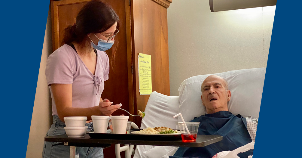 Maeve Jones, my sister, feeding my Grandpa. He suffered a stroke in September of 2019 and was in a skilled nursing facility from then until he passed in December of 2021. He declined more rapidly during COVID, and this picture was taken 6 months before his passing. Photo courtesy of Melissa Jones